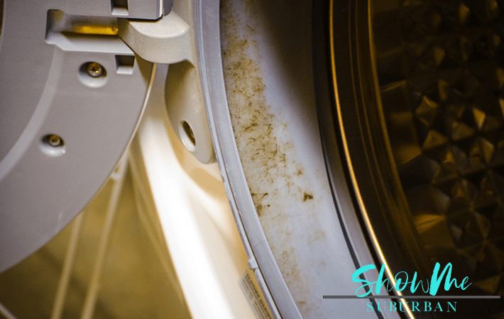 Washing machine with text overlay | Keeping your rubber washing machine gasket free of mold and mildew is an important part of home maintenance, and it's surprisingly quick and easy! These 3 simple steps to remove mold from a front-load washing machine seal are exactly what you need!